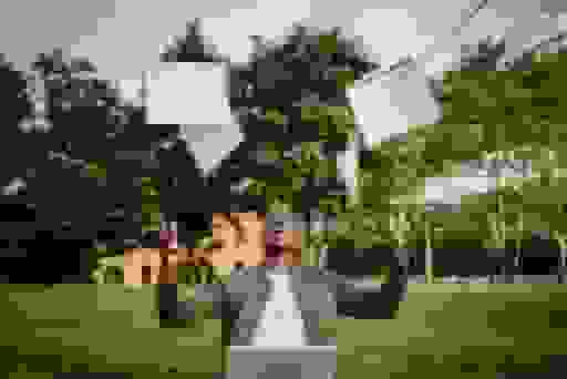 professional headshot of a black man throwing books in the sky