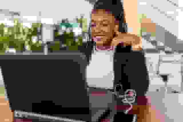 ai LinkedIn Headshot woman working laptop