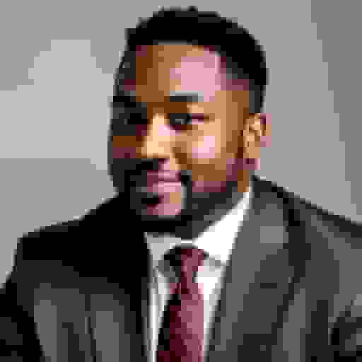 professional headshot of a black man with black suit
